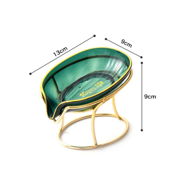 A decorative leaf-shaped soap dish with a green and gold finish, measuring 13cm long.