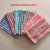 A collection of random mixing colored absorbent cotton cleaning cloths laid out in a row.