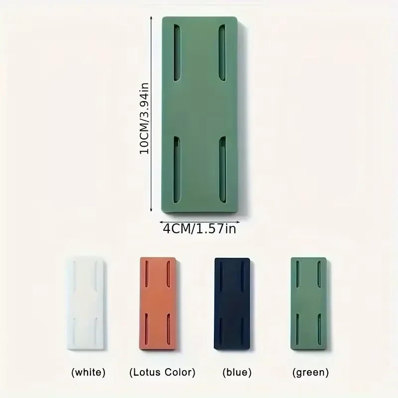 A set of four self-adhesive desktop cable organizer holders in white, lotus color, blue, and green.