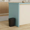 A modern light blue kitchen island with a cream countertop and a dark trash can placed in front of it.