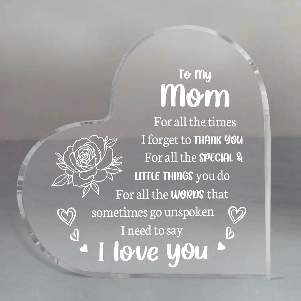 A clear acrylic heart engraved with the message I love you mom for all the times I forget to thank you and special little thi