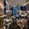 A collection of silver and black heart-shaped balloons displayed in a luxurious, modern room setting.
