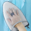 A hand is placed on a portable, clear mesh ironing board used for garment steaming.