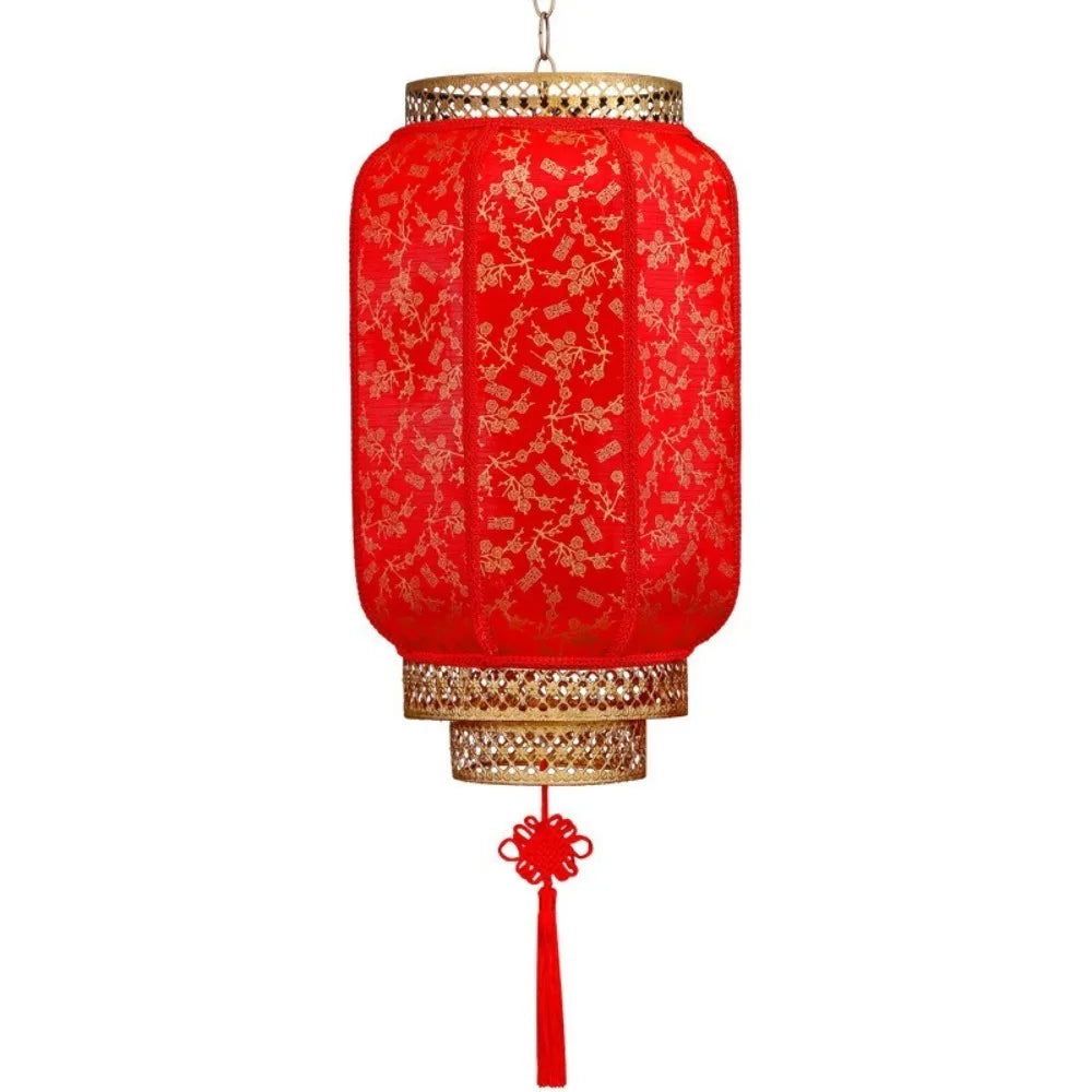 A durable antiqued red Chinese lantern with a gold rim and decorative tassel.