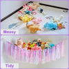 A comparison showing messy and tidy arrangements of pink and yellow stuffed animals.