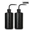A pair of black squeeze bottles with measurement lines for tattoo solutions