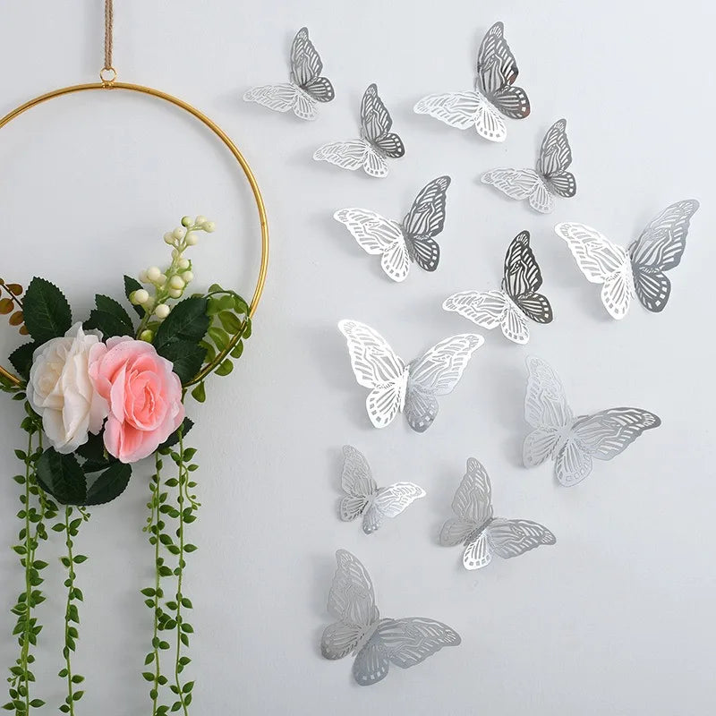 A collection of silver and gray 3D decorative butterfly wall stickers hanging from a gold hoop.