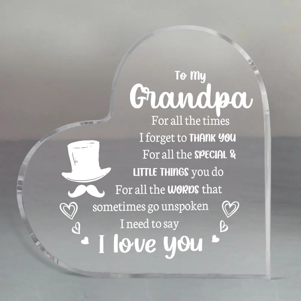 A clear acrylic heart-shaped keepsake engraved with the message To my Grandpa For all the times I forget to thank you For all