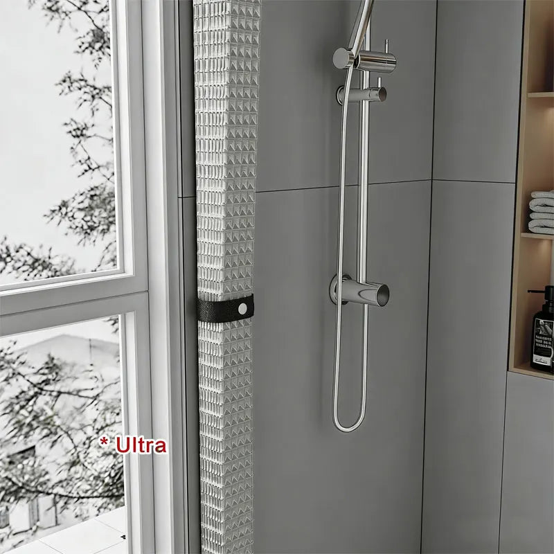 A silver magnetic shower curtain rod and hook system mounted on a gray wall panel.