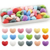A collection of ten colorful silicone heart-shaped charm beads in various shades and colors.
