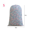 Light blue drawstring storage bag with a pink floral pattern for laundry and bedding