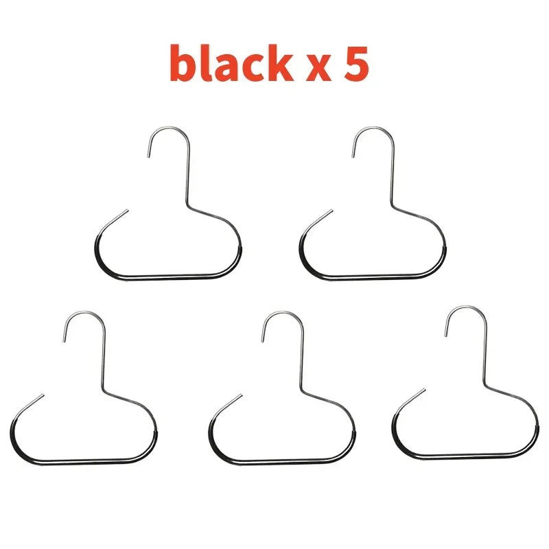 Five black metal hat hangers or racks.