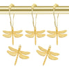 A set of gold-toned dragonfly shower curtain hooks hanging from a brass rod.