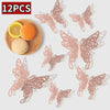 Twelve pink and gold decorative butterfly wall stickers displayed on a light background.