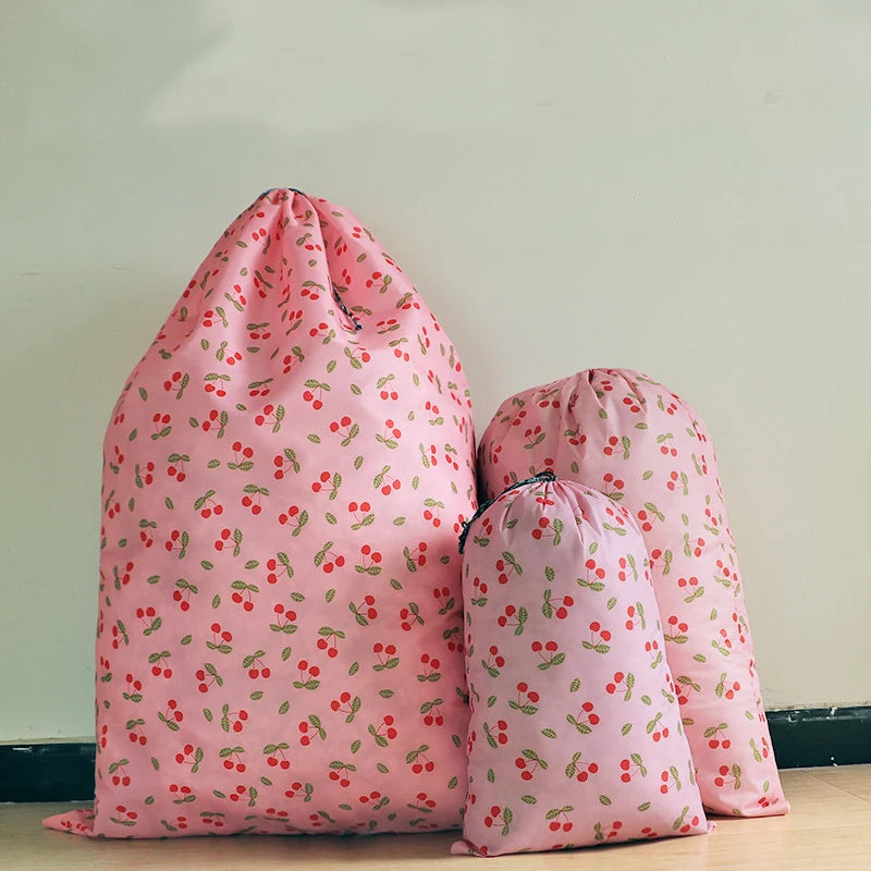 A pink drawstring storage bag with a floral pattern is shown in a vertical arrangement.