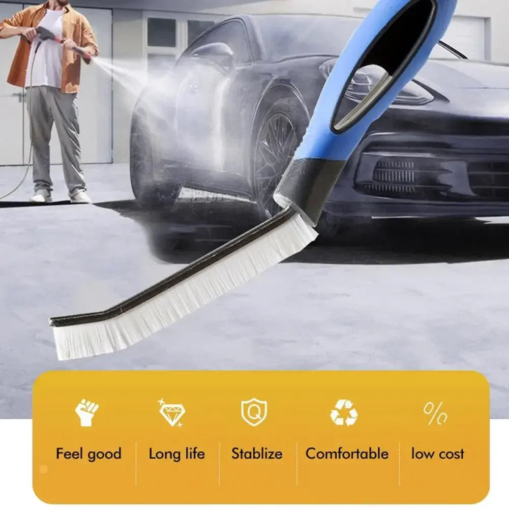 A blue hard bristle crevice cleaning brush with a non-slip handle is shown cleaning a black car.