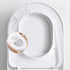 A white disposable toilet seat is shown in an oval, curved packaging design.