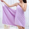 A woman wearing a lavender bath wrap towel, demonstrating its soft fabric and absorbent design.