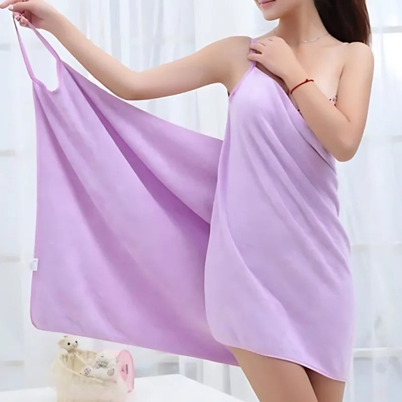 A woman wearing a lavender bath wrap towel, demonstrating its soft fabric and absorbent design.