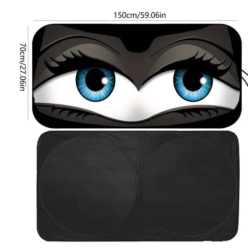 A close-up view of a cartoon folding car sunshade windshield protector featuring large blue eyes.