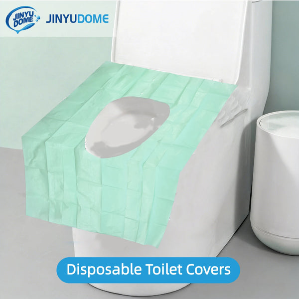 A disposable light green toilet cover placed on a white toilet bowl.