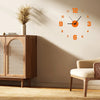 A wall clock with an antique style design featuring orange numerals and hands on a light beige wall.
