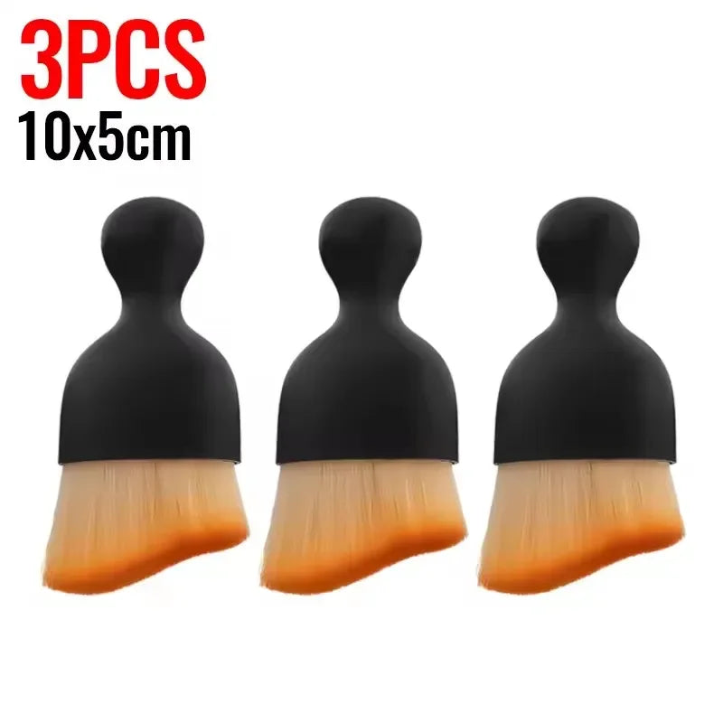 Three black silicone cleaning brushes with orange bristles, 10x5cm size.