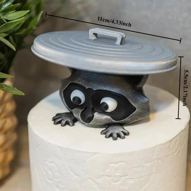 A decorative toilet paper holder shaped like an owl with a lid, sitting on a white cake.