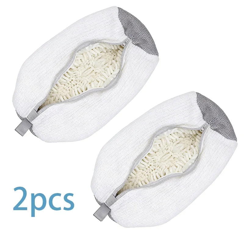 Two white reusable shoe washing bags with gray zippers shown from above