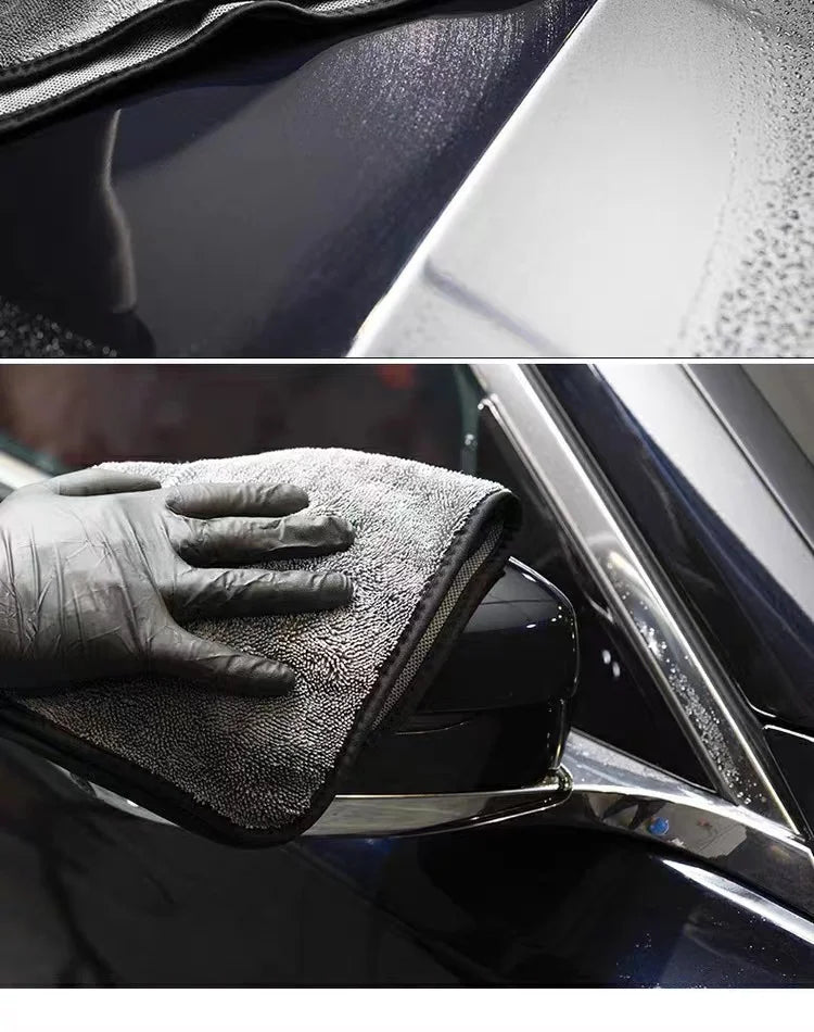A black microfiber towel is shown cleaning a car's exterior surface.