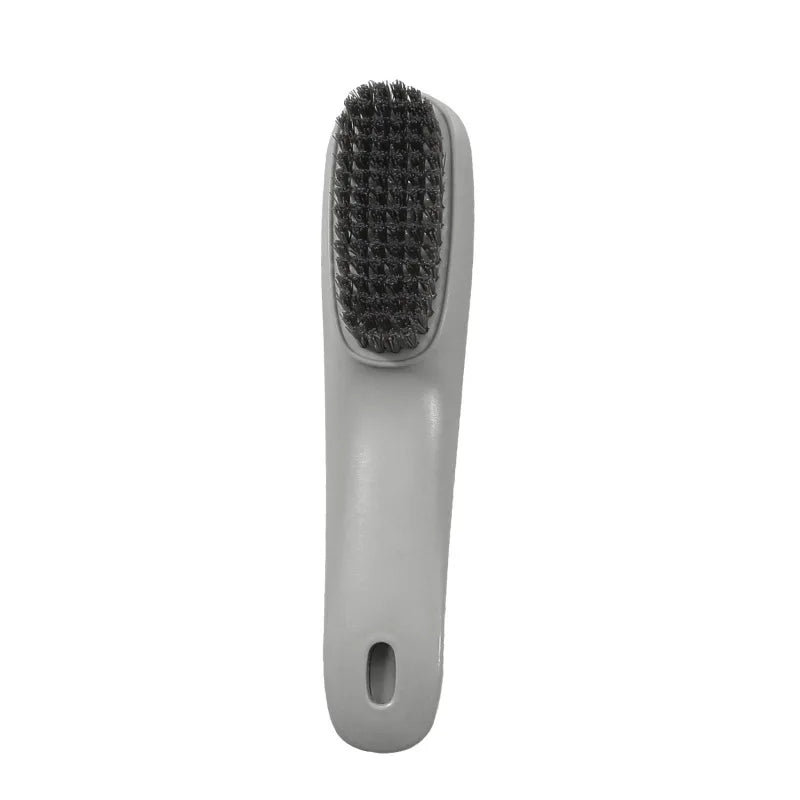 Brosse multifonction grise pour nettoyer les chaussures et les vêtements, avec une tête à poils.