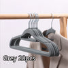 Grey velvet slim hangers set with 20 pieces hanging on a wooden rod