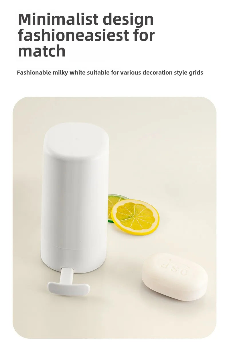 A white portable soap bar grinder with a wall-mount design is shown next to a slice of lemon.