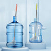 A clear blue plastic bucket with a stainless steel brush and yellow handle is displayed on a white surface.