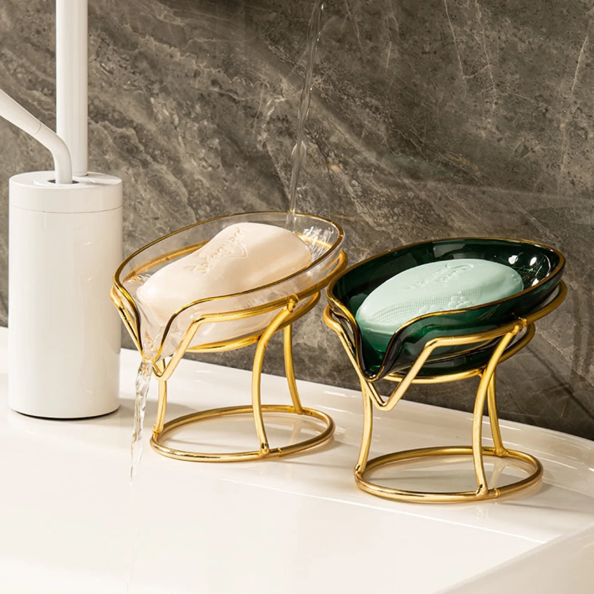 A gold-toned decorative leaf soap dish holding a bar of white soap is being filled with water.