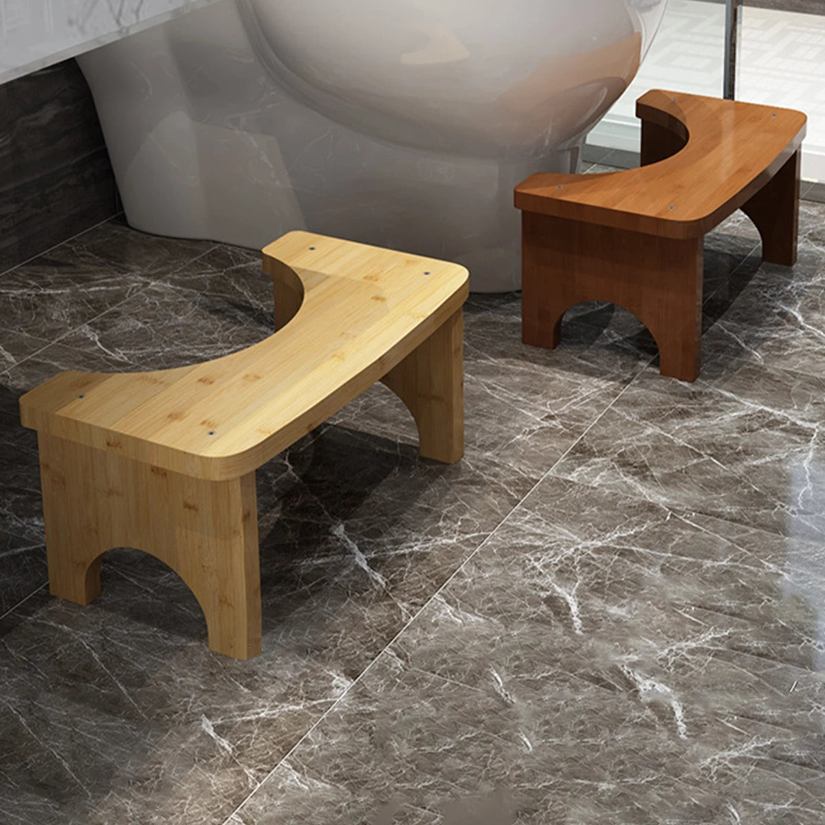 A light wood portable bamboo toilet squat stool placed on a marble floor next to a modern toilet.