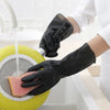 A person wearing black rubber cleaning gloves is washing a pink dish in a yellow basin.