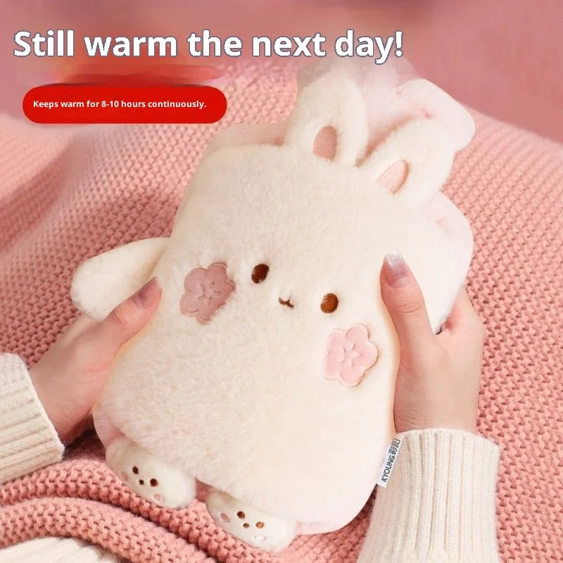 A pink plush rabbit hot water bottle being held by hands, demonstrating its warmth.