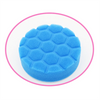 A blue foam cleaning brush head set with sponge, scouring pad, and polishing disc shown in a circular view.