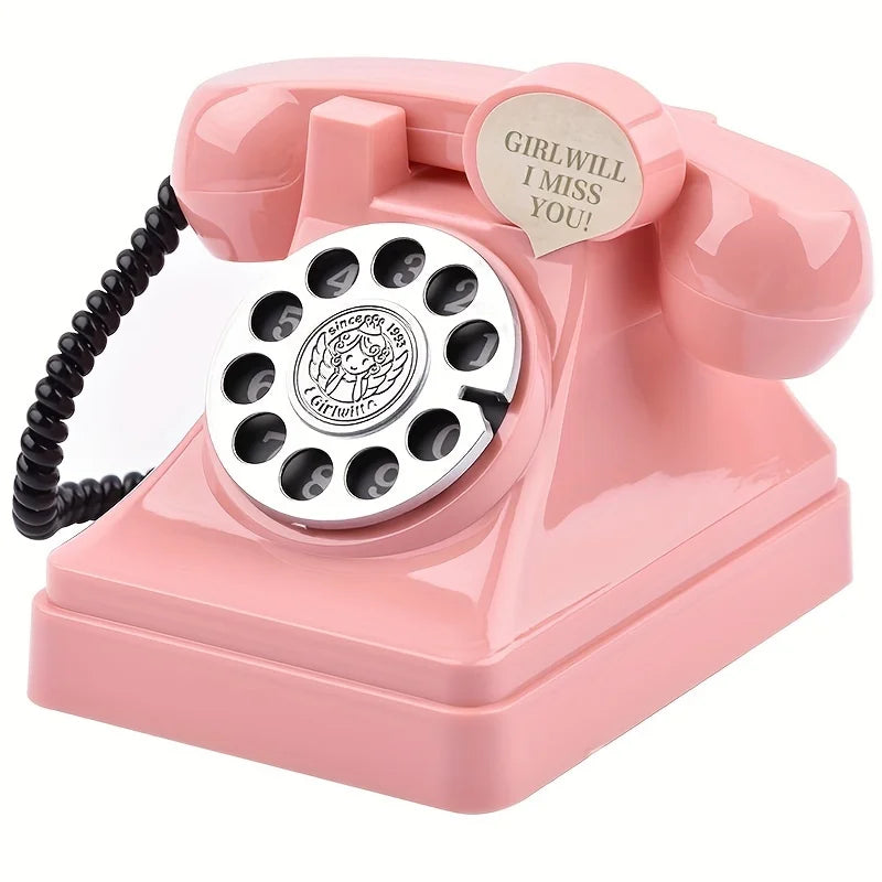 A pink retro telephone shaped like a money jar with a circular dial and a tag that reads Girlwill I miss you