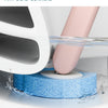 A white toilet brush is cleaning a blue sponge in water, demonstrating groove cleaning without leaving dead corners.