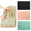 A foldable waterproof jewelry organizer bag shown open with various jewelry pieces and accessories displayed inside.