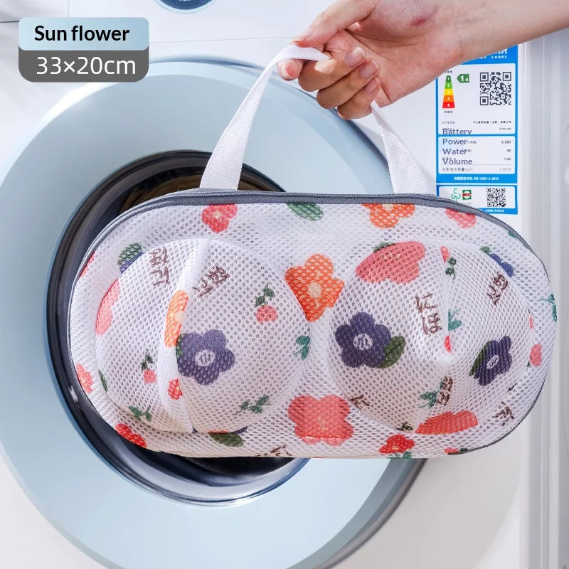 A white mesh laundry bag with a floral pattern is shown being placed inside a washing machine drum.