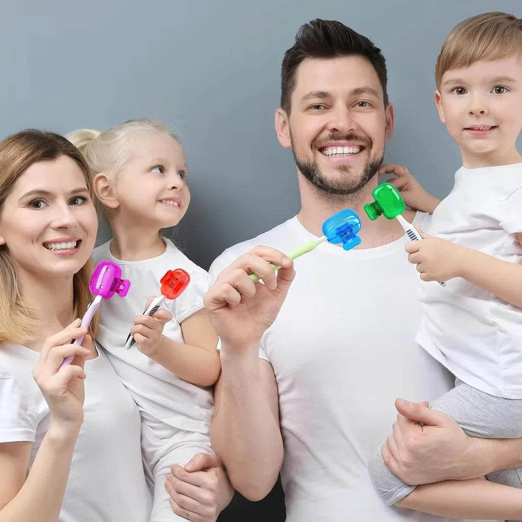 A family of four smiling while holding various colored reusable toothbrush head covers for electric brushes.