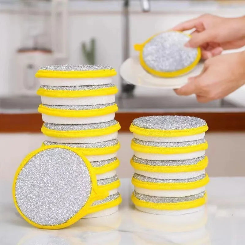 A stack of yellow and white double-sided kitchen cleaning towels and dish sponges being handled by a hand.
