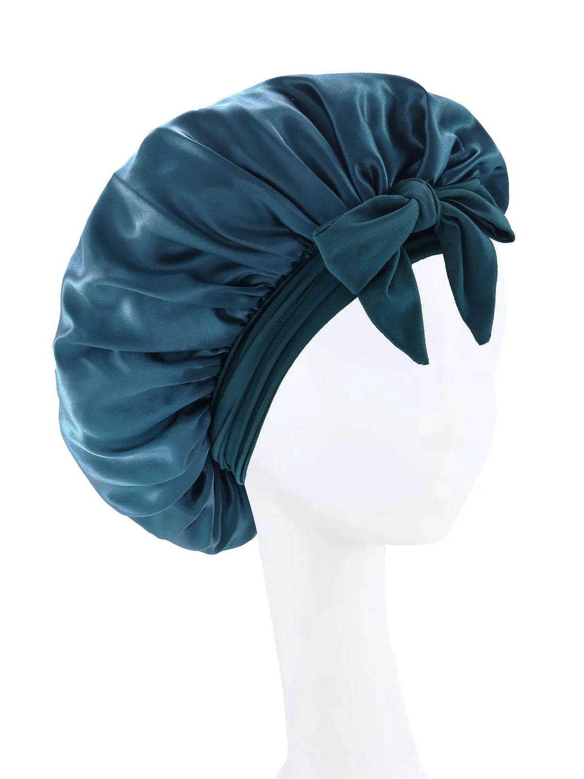 A dark teal silky satin sleep bonnet tied in a bow displayed on a white mannequin head.