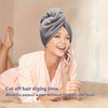 A woman is using a microfiber hair drying wrap towel while smiling and talking on a phone.