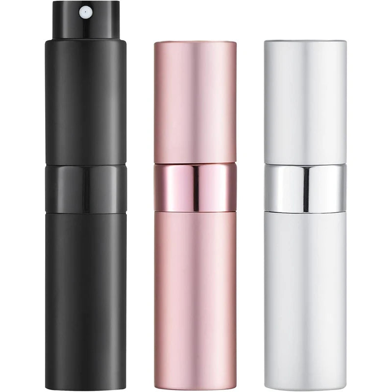 A set of three travel perfume atomizers in black, rose gold, and silver.