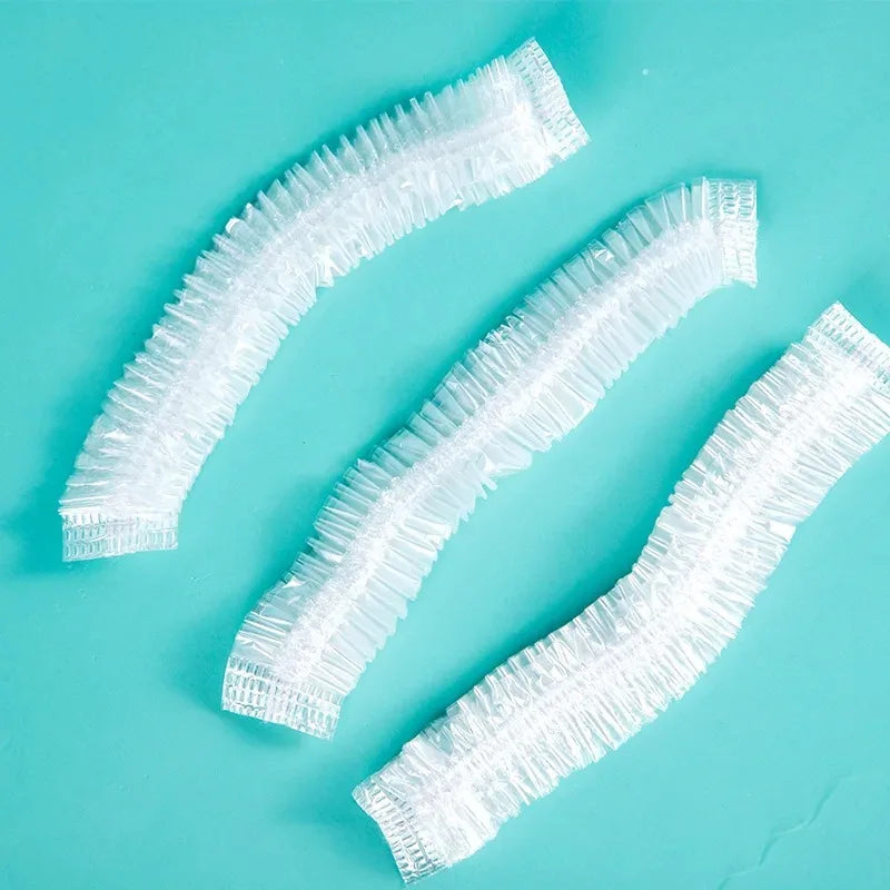 White reusable disposable food covers with decorative bows laid diagonally on a light blue surface.
