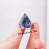 A hand holds a natural stone chakra pyramid set, featuring blue and gray stones, demonstrating its size.